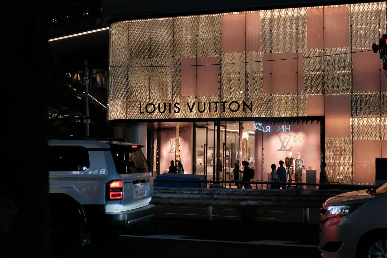 Luxury brands are opening cafes to attract new customers with affordable options.